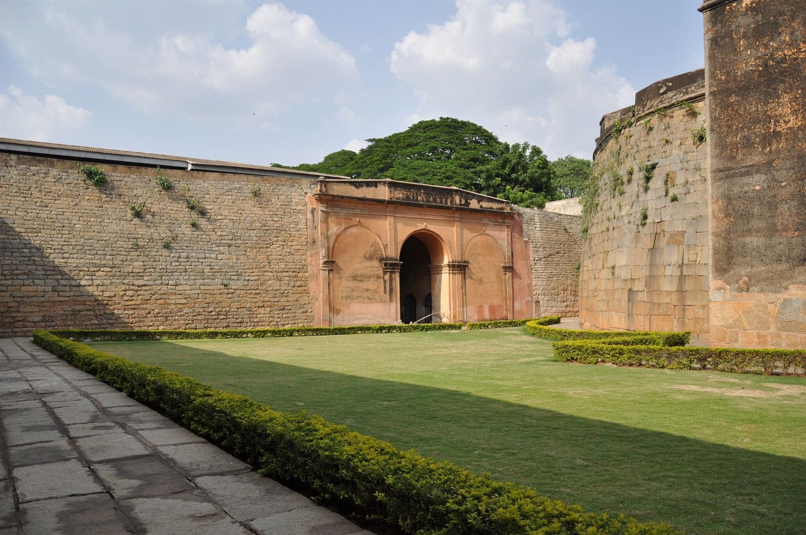 Main view of Bengaluru Fort — surviving stone gateway, arched entrance and green courtyard in Bengaluru, Karnataka, India